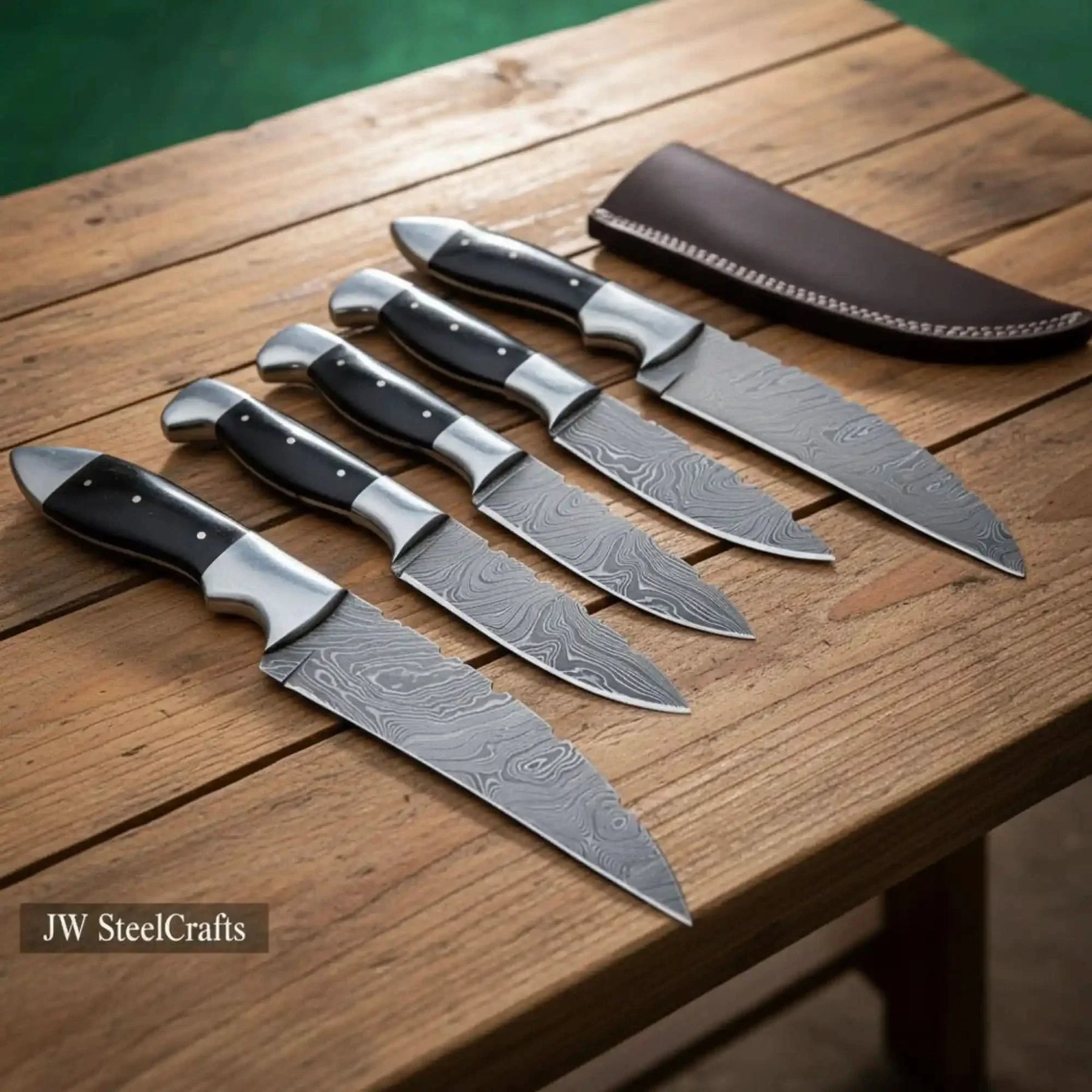 Handmade damascus steel knife with premium handle on dark surface