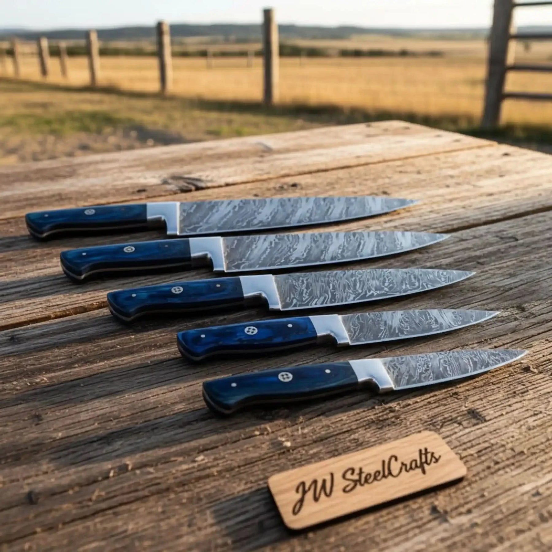Handmade damascus steel knife with wood handle on dark surface