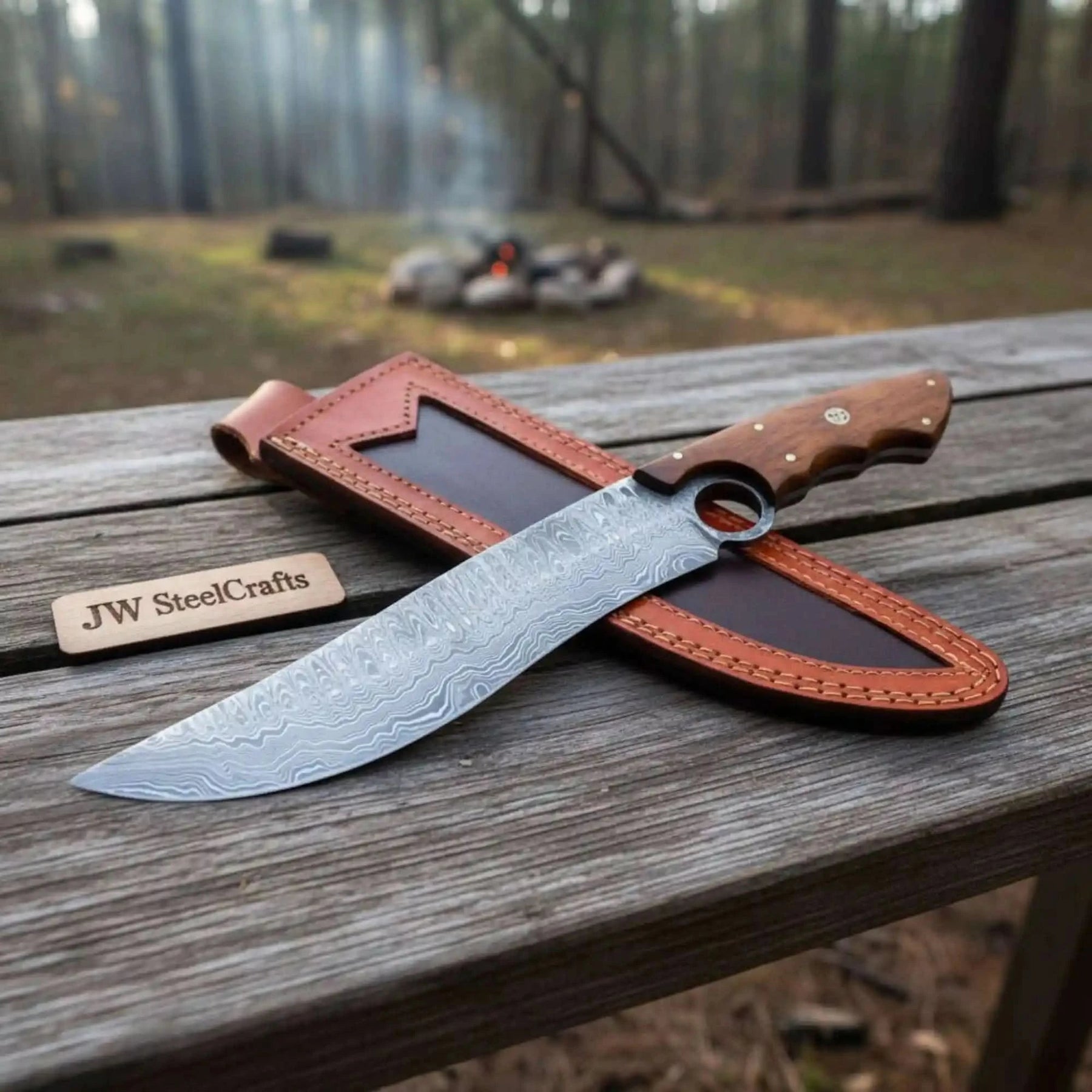 Handmade damascus steel knife with premium handle on dark surface