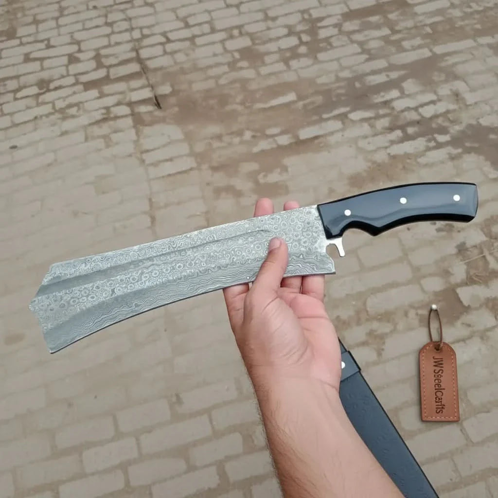 Handmade damascus steel knife with resin handle on dark surface
