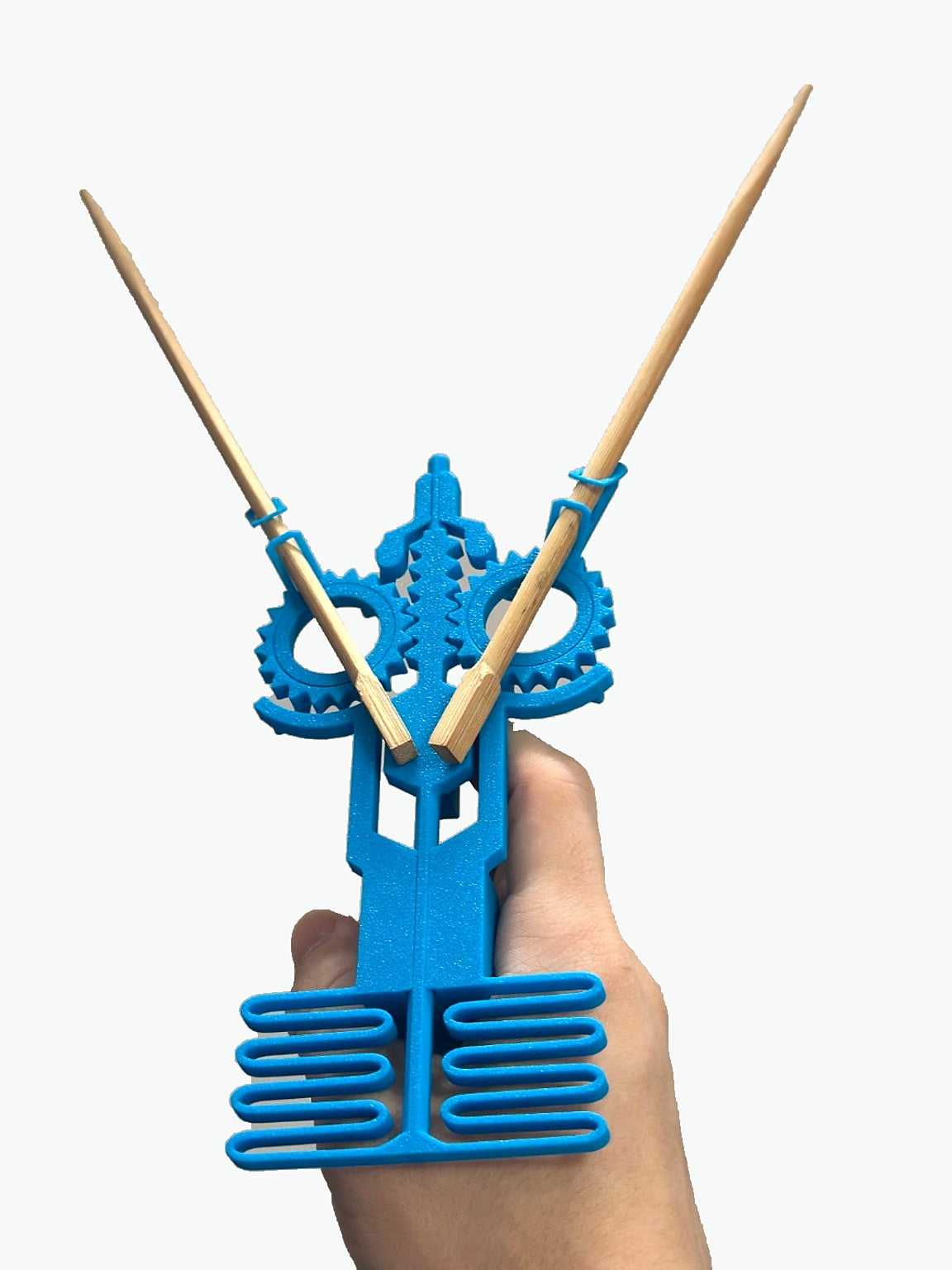 Blue crossbow chopstick holder by The Tween Space shown with chopsticks for demonstration; chopsticks not included.