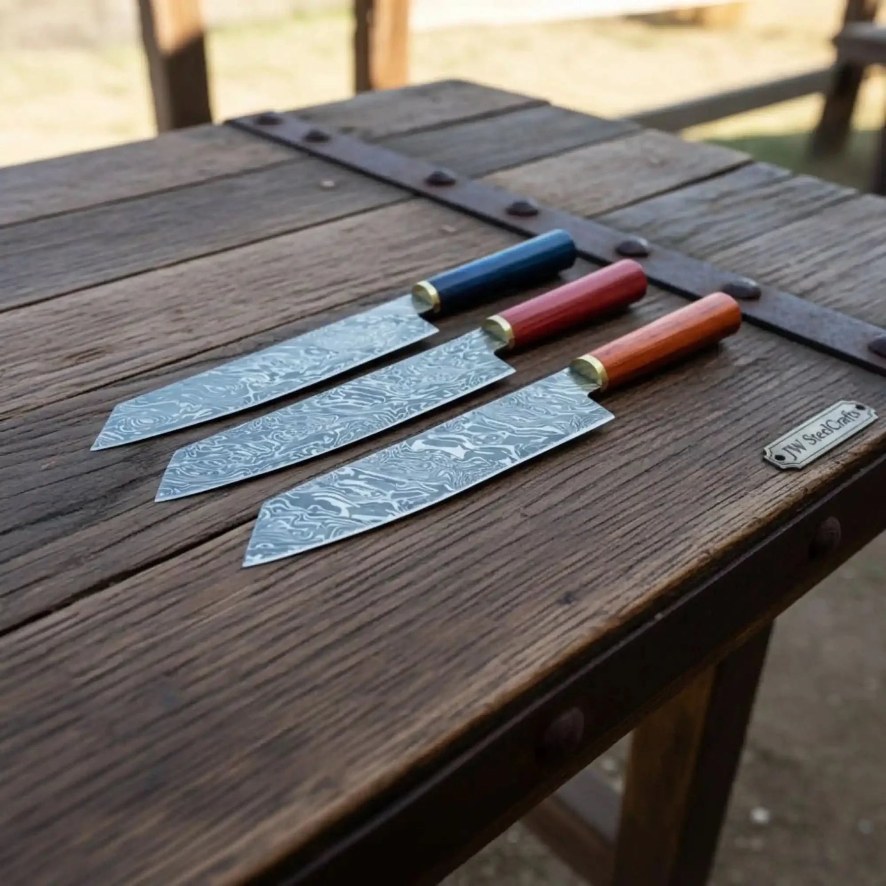 Handmade damascus steel knife with wood handle on dark surface