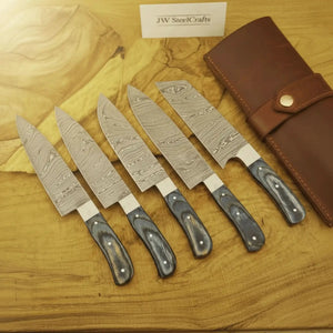 Handmade damascus steel knife with premium handle on dark surface