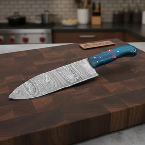 Handmade damascus steel knife with wood handle on dark surface