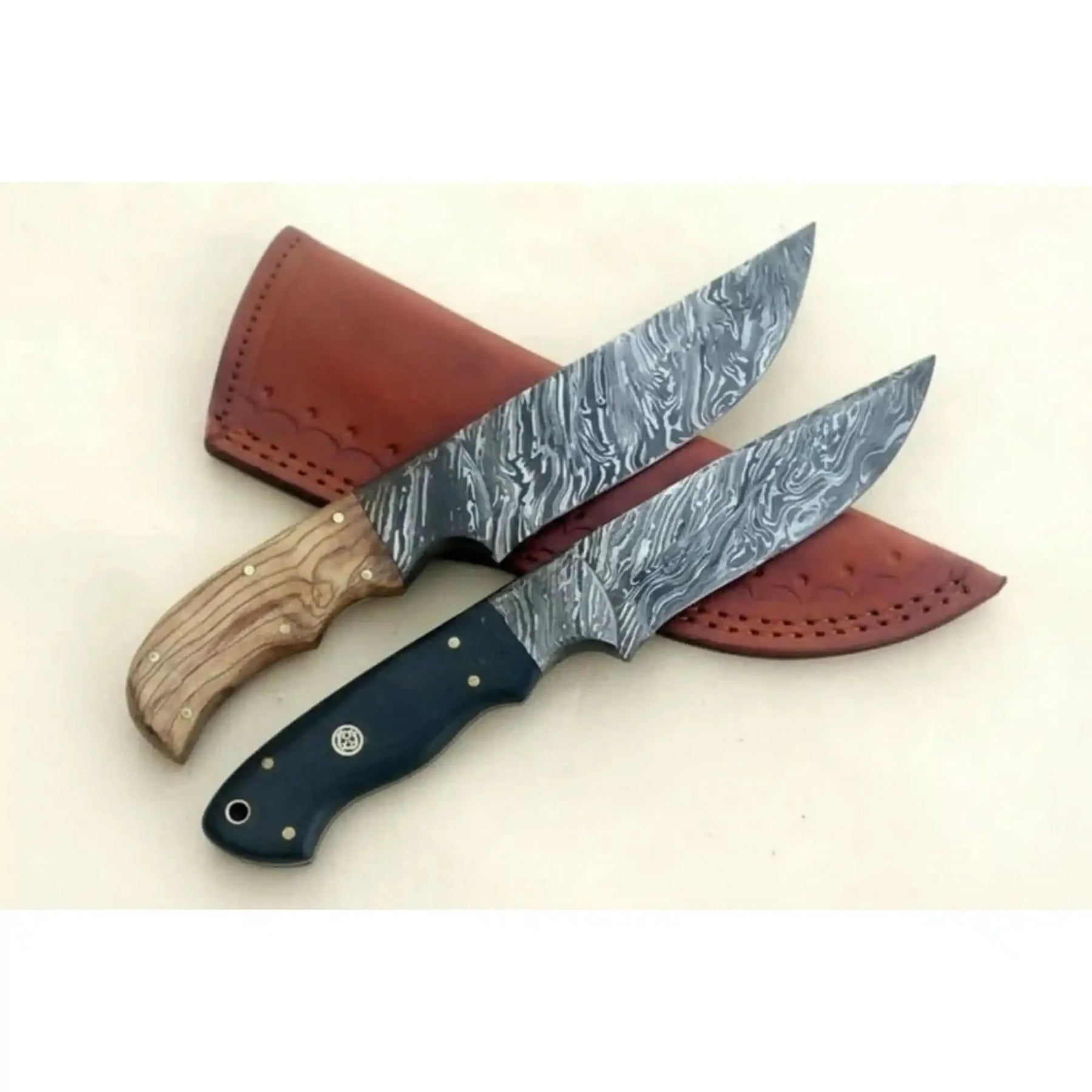 Handmade damascus steel knife with leather handle on dark surface