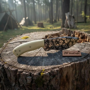 Handmade damascus steel knife with resin handle on dark surface