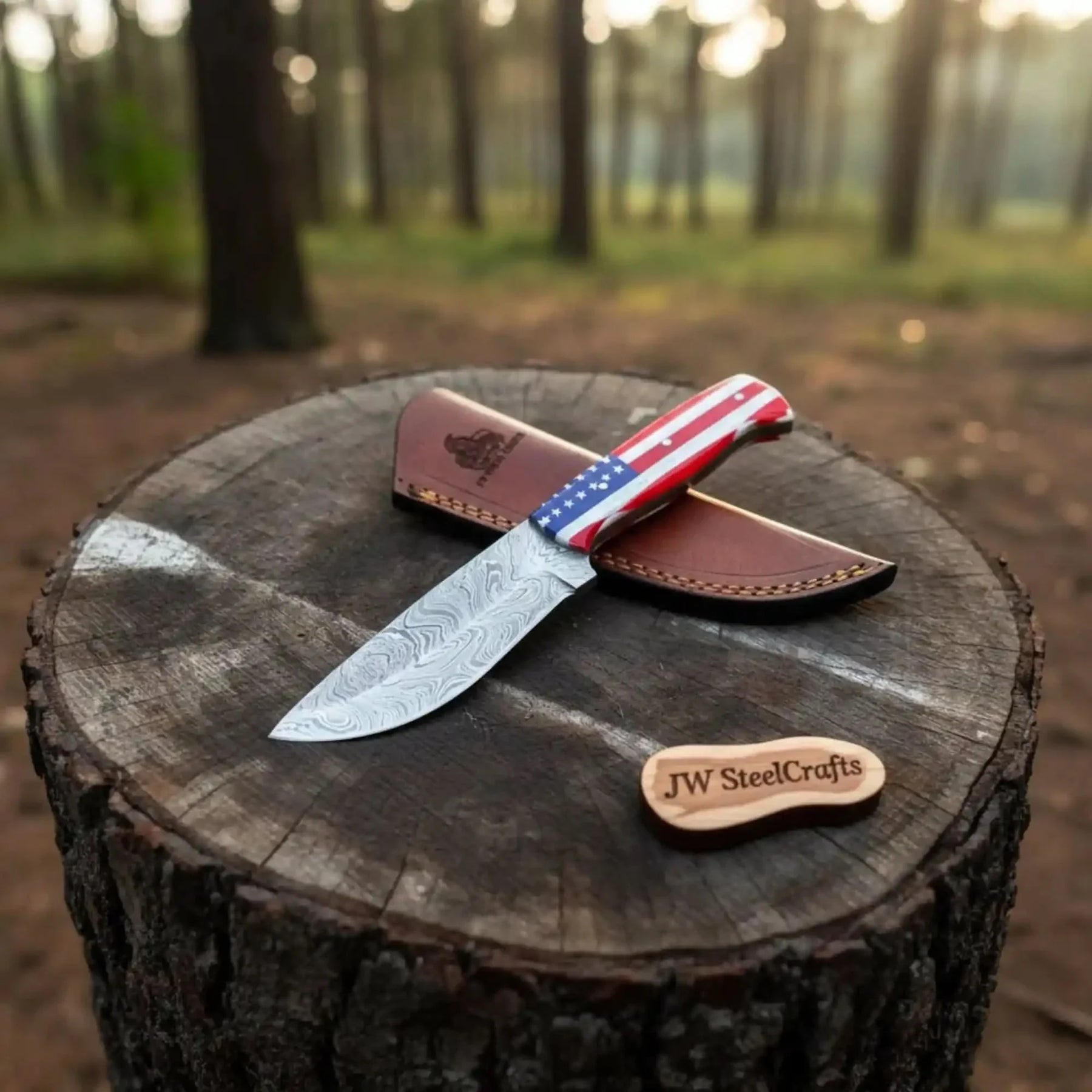 Handmade damascus steel knife with resin handle on dark surface