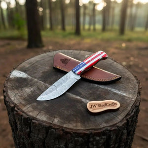 Handmade damascus steel knife with resin handle on dark surface