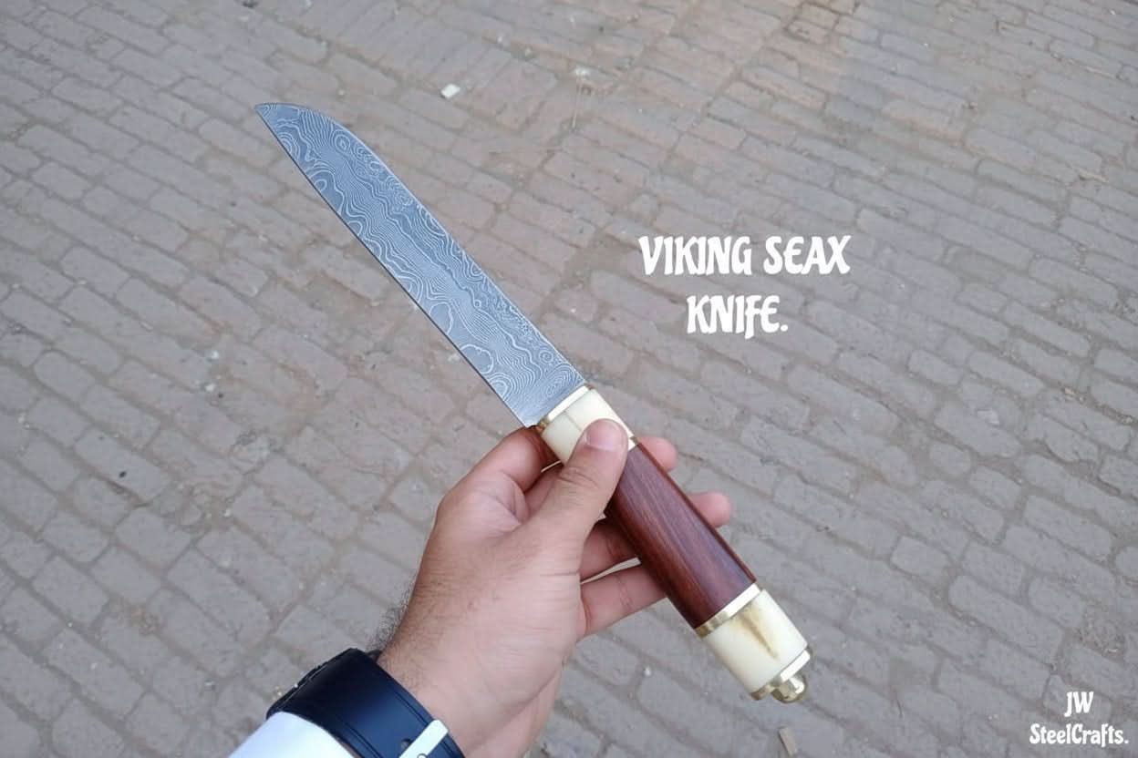 Handmade damascus steel knife with premium handle on dark surface