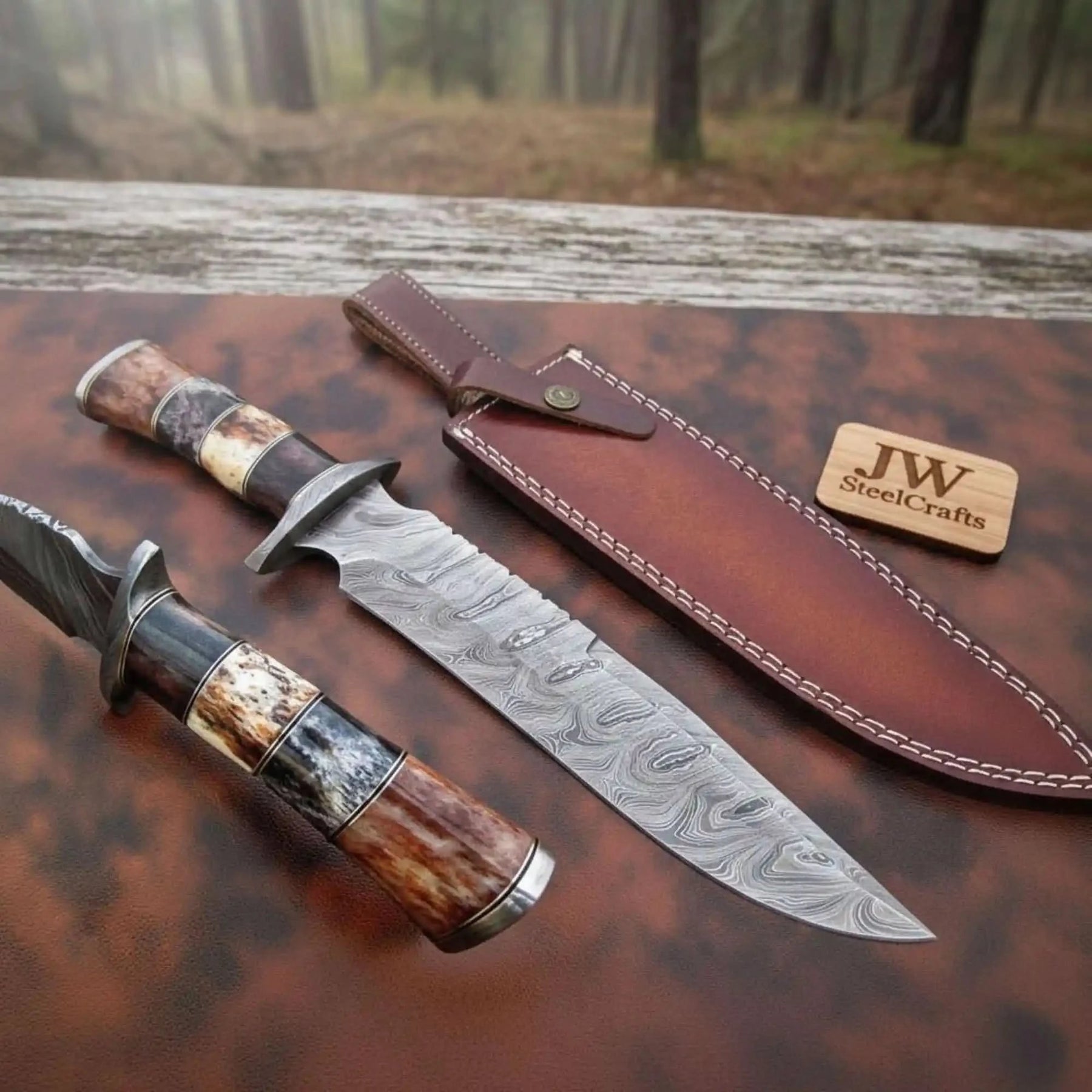Handmade damascus steel knife with premium handle on dark surface