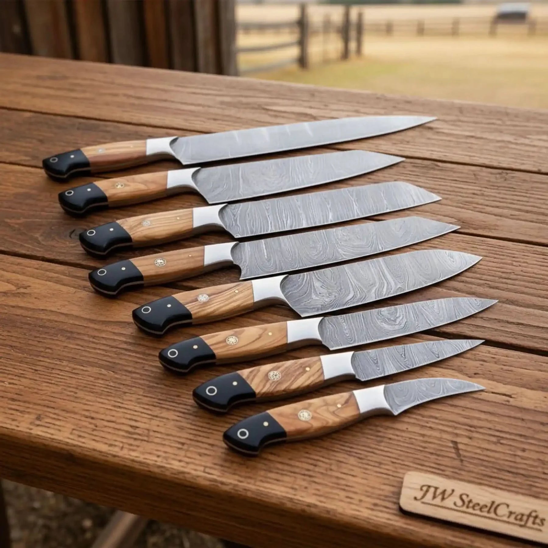 Handmade damascus steel knife with wood handle on dark surface