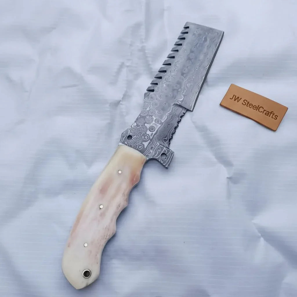 Handmade damascus steel knife with bone handle on dark surface
