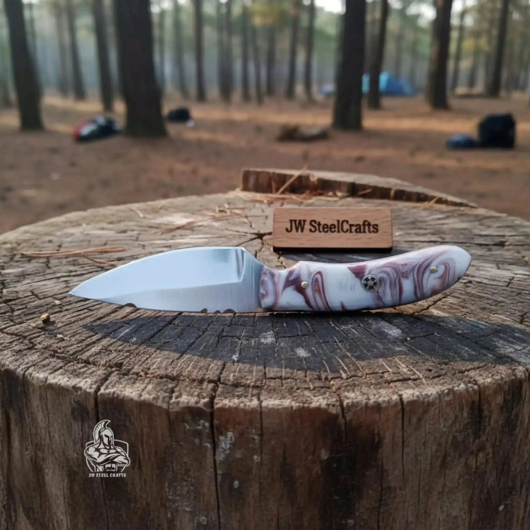 Handmade damascus steel knife with resin handle on dark surface