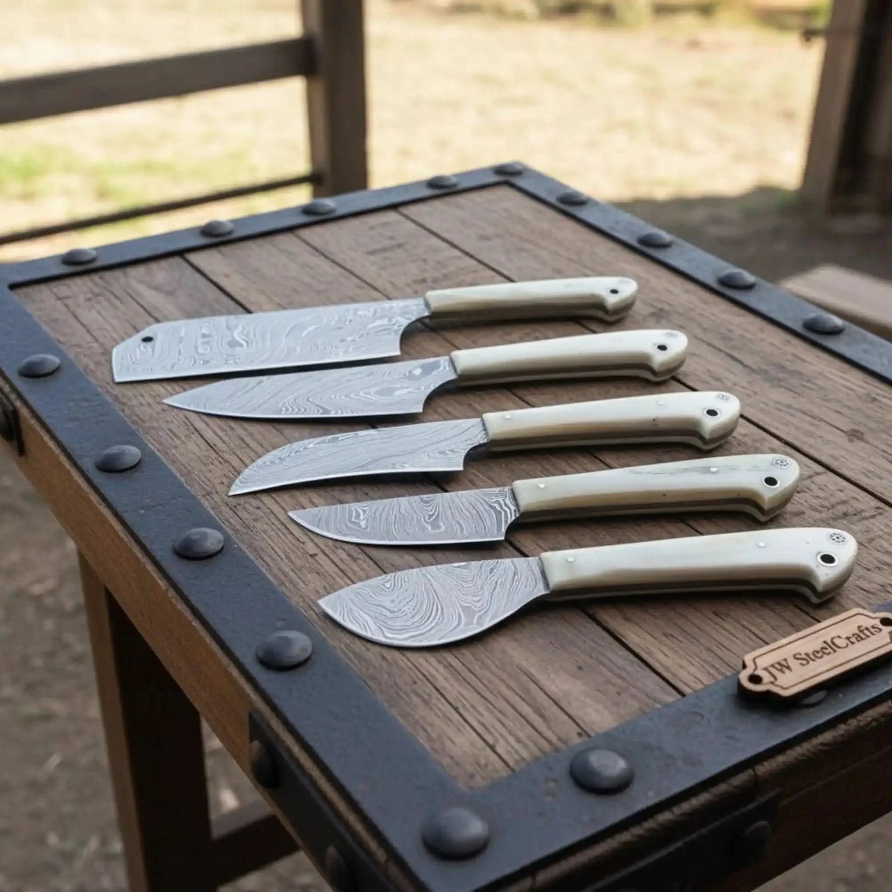 Handmade damascus steel knife with micarta handle on dark surface