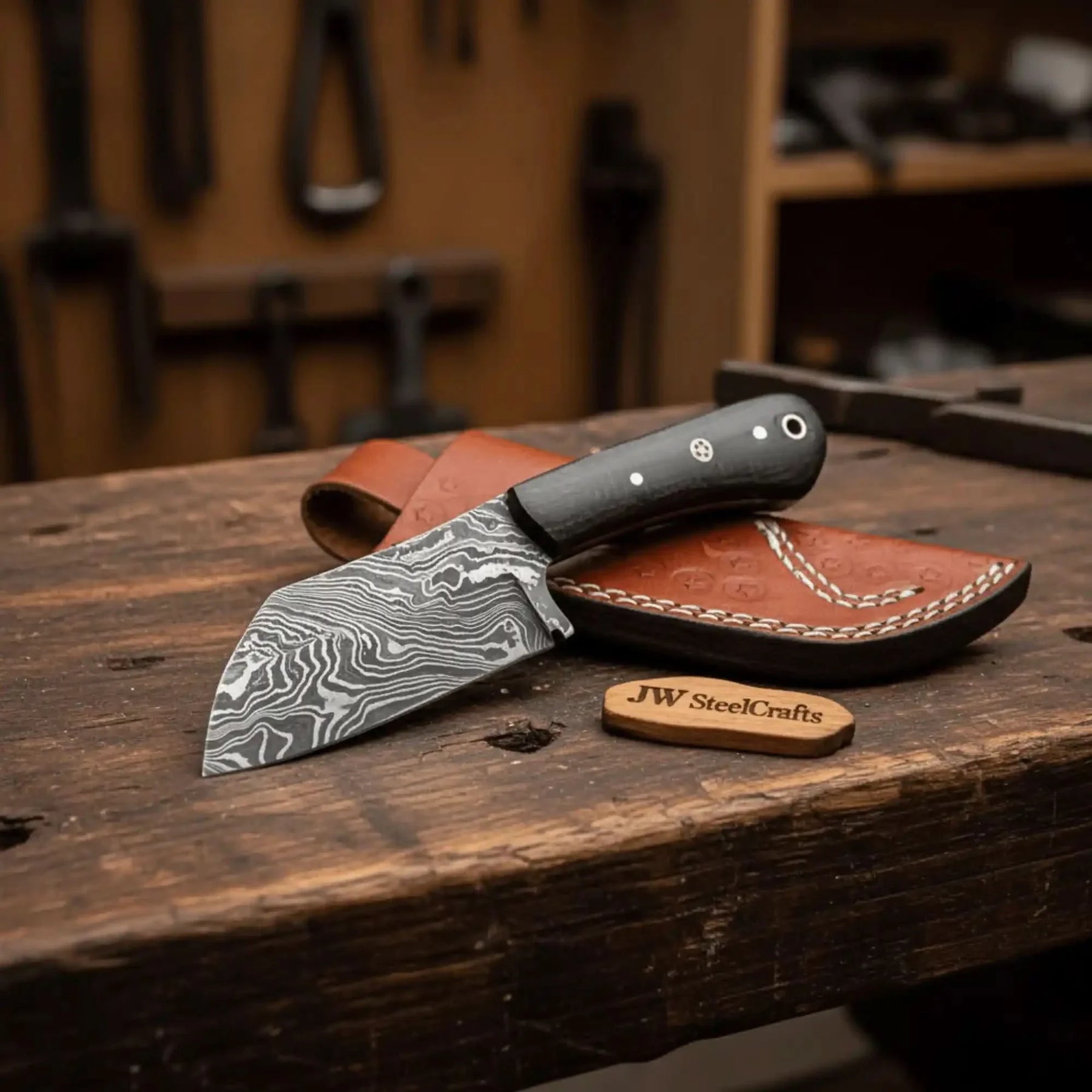 Handmade damascus steel knife with micarta handle on dark surface